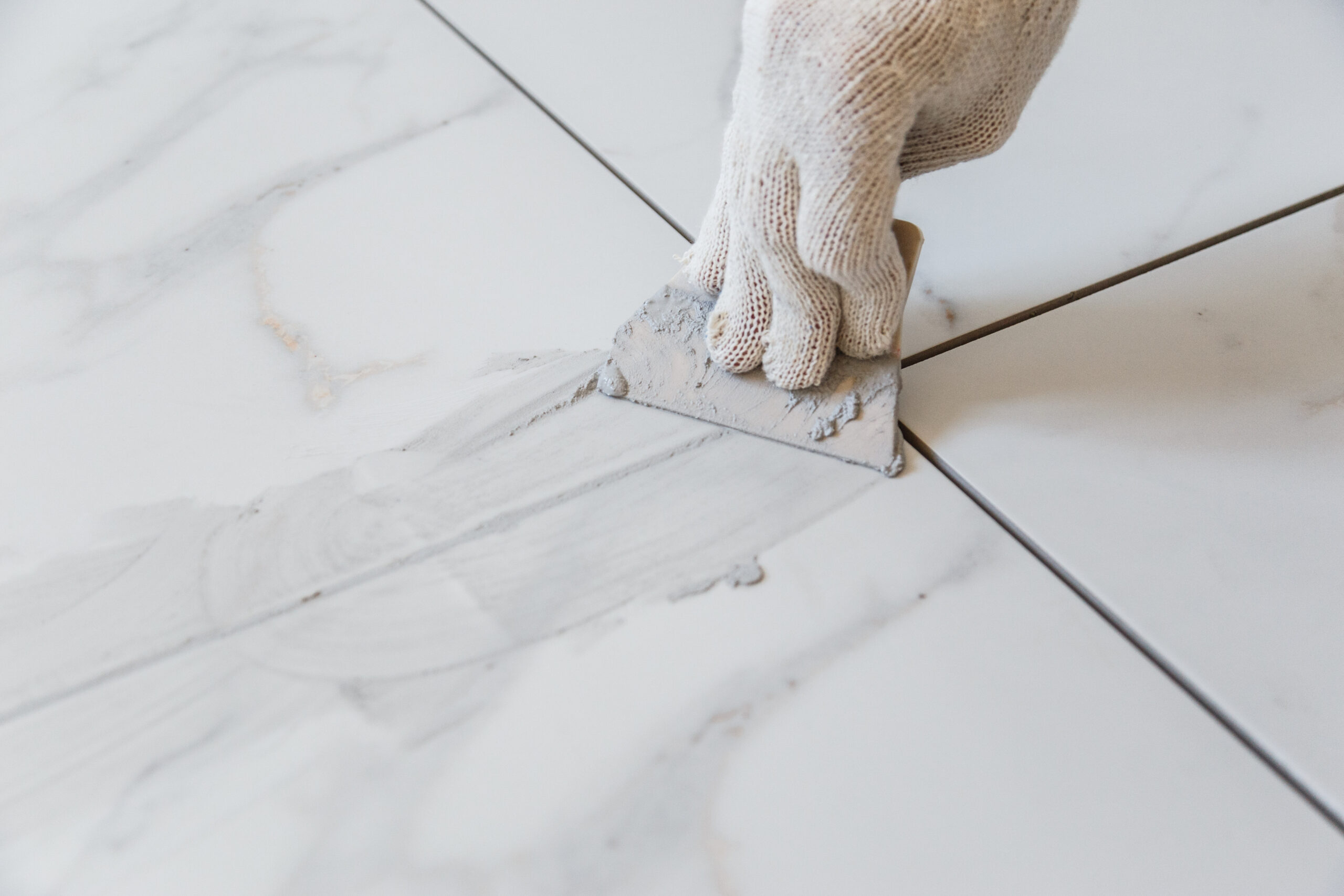 Stone-look floor tiles being grouted